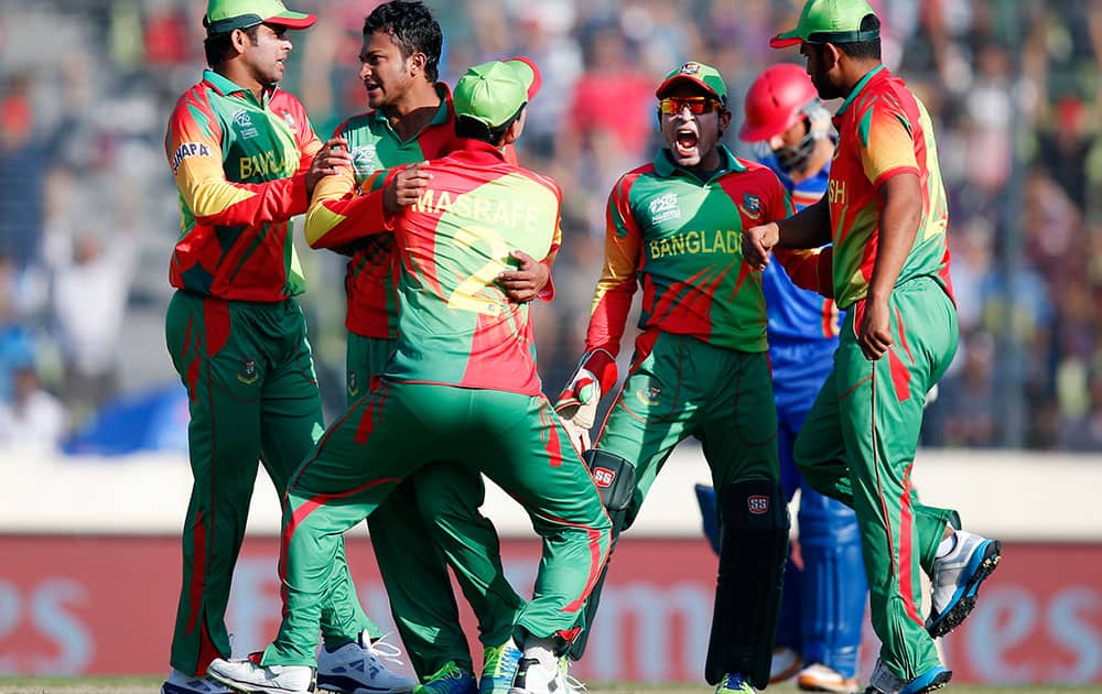 Bangladesh's bowler Shakib Al Hasan, second from left, celebrates with teammates the dismissal of Afghanistan's batsman Najibullah Taraki during their ICC Twenty20 Cricket World Cup opening match in Dhaka.
