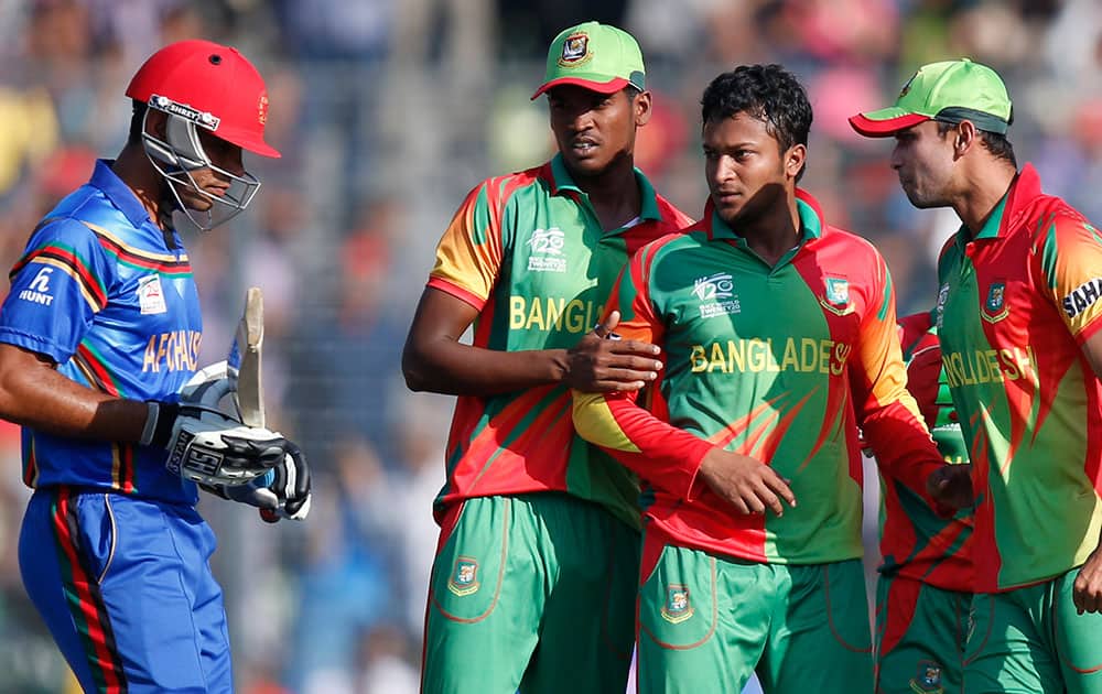 Bangladesh's bowler Shakib Al Hasan, second from right, reacts after taking the wicket of Afghanistan's batsman Najibullah Taraki, left, during their ICC Twenty20 Cricket World Cup opening match in Dhaka.