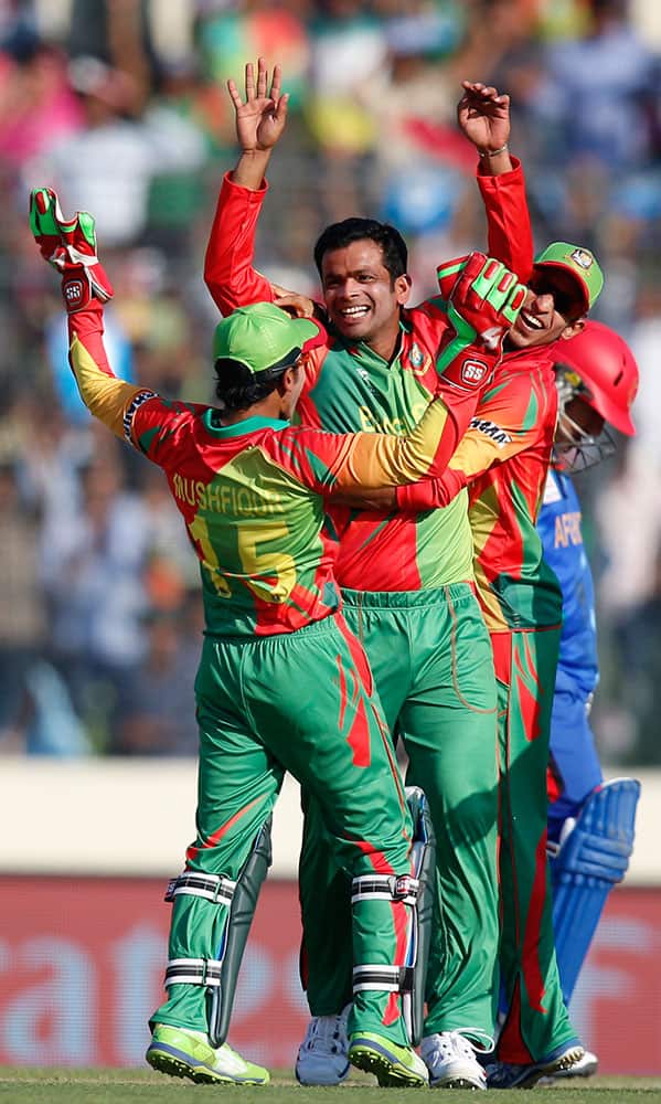 Bangladesh's bowler Abdur Razzak, center, celebrates with teammates after taking the wicket of Afghanistan's batsman captain Mohammad Nabi during their ICC Twenty20 Cricket World Cup opening match in Dhaka.