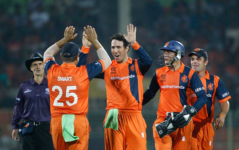 Netherlands bowler Ben Cooper, center, celebrate with his teammates the wicket of United Arab Emirates captain Khurram Khan during their ICC Twenty20 Cricket World Cup match in Sylhet, Bangladesh.