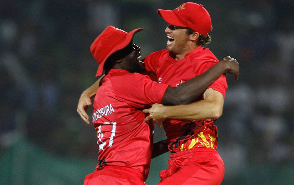 Zimbabwe's Elton Chigumbura, left, celebrates with a teammate the wicket of Ireland's Max Sorensen during their ICC Twenty20 Cricket World Cup match in Sylhet, Bangladesh.