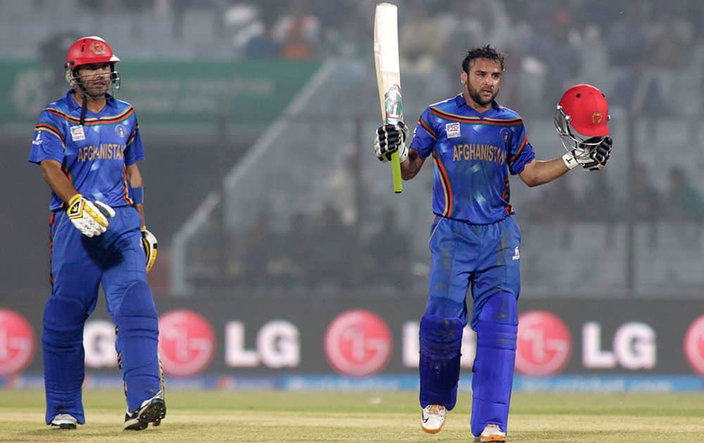 Afghanistan cricketers Shafiqullah, right and captain Mohammad Nabi celebrate their victory over Hong Kong during their ICC Twenty20 Cricket World Cup match in Chittagong, Bangladesh.