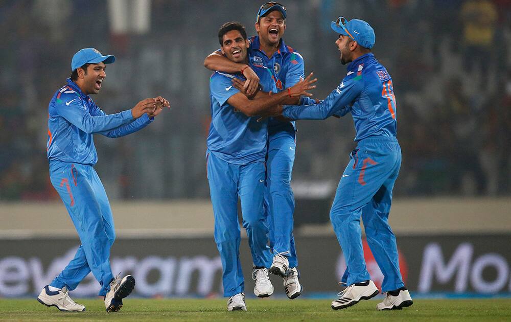 India's Bhuvneshwar Kumar celebrates with teammates the dismissal of Pakistan's batsman Kamran Akmal during their ICC Twenty20 Cricket World Cup match in Dhaka, Bangladesh.