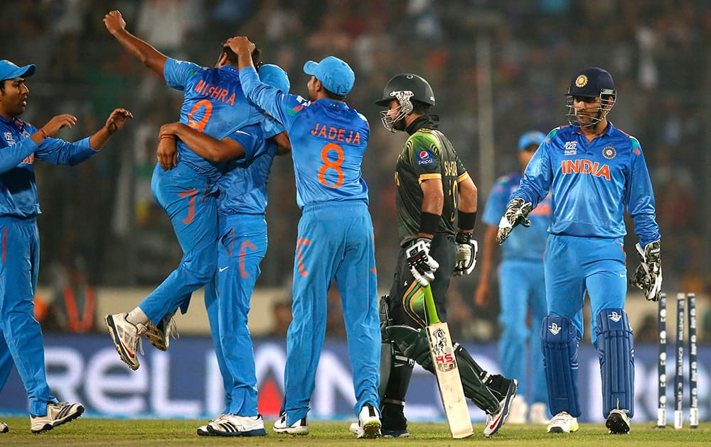 Members of Indian cricket team celebrate the dismissal of Pakistan's batsman Ahmed Shehzad, second right, during their ICC Twenty20 Cricket World Cup match in Dhaka, Bangladesh.
