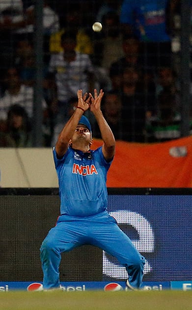 India's Suresh Raina prepares to take the catch to dismiss Pakistan's Umar Akmal during their ICC Twenty20 Cricket World Cup match in Dhaka, Bangladesh.