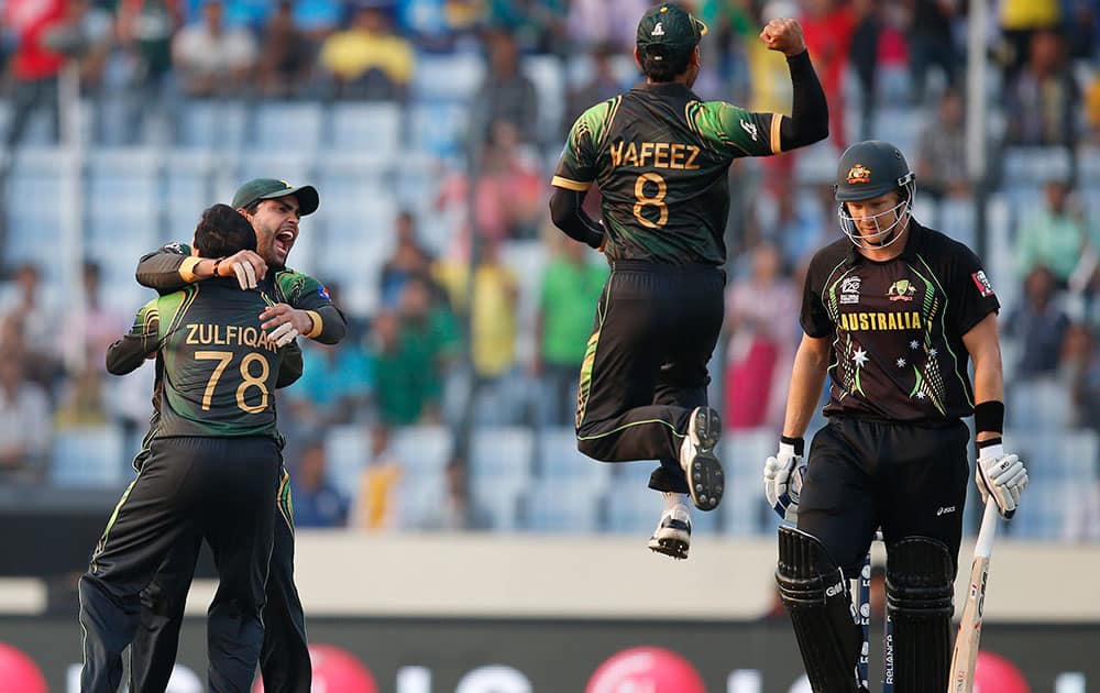 Pakistan players celebrate the dismissal of Australia's batsman Shane Watson, right, during their ICC Twenty20 Cricket World Cup match in Dhaka, Bangladesh.