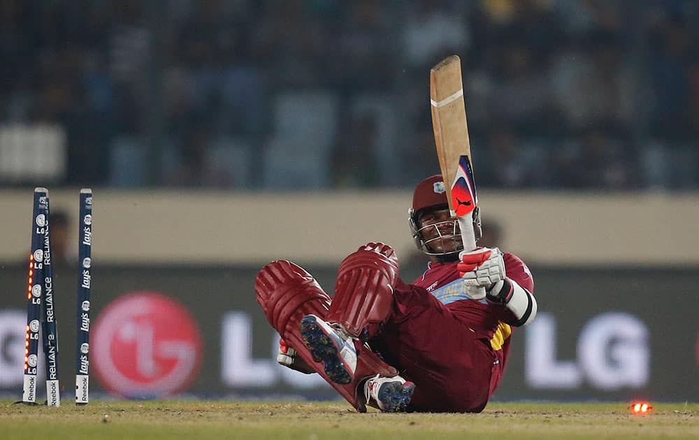 West Indies' batsman Marlon Samuels falls on the ground after he is stumped by India's captain Mahendra Singh Dhoni during their ICC Twenty20 Cricket World Cup match in Dhaka.