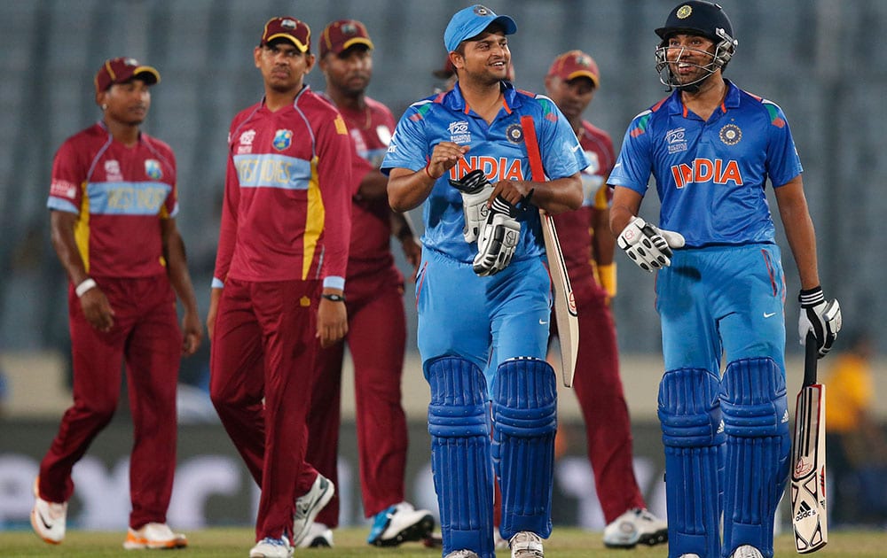 India's batsmen Rohit Sharma, right, and Suresh Raina, second right, smile as they leave the ground after their team's win over West Indies' in the ICC Twenty20 Cricket World Cup match in Dhaka.