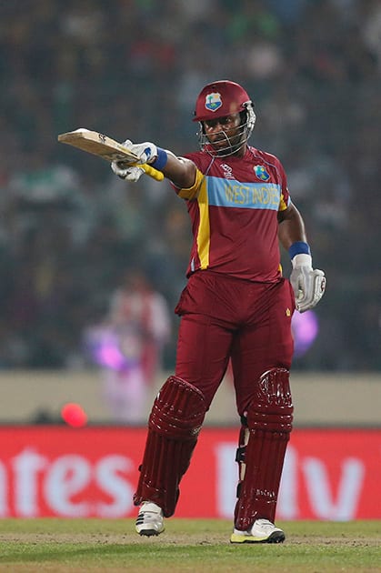 West Indies' batsman Dwayne Smith gestures towards his team's dug out after scoring a half century during their ICC Twenty20 Cricket World Cup match against Bangladesh in Dhaka, Bangladesh.