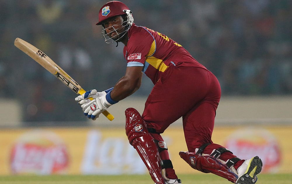 West Indies' batsman Dwayne Smith watches his shot during their ICC Twenty20 Cricket World Cup match against Bangladesh in Dhaka, Bangladesh.