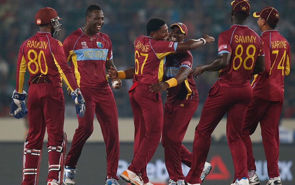 West Indies' bowler Krishmar Santokie, third left, celebrates with teammates the dismissal of Bangladesh batsman Shakib Al Hasan during their ICC Twenty20 Cricket World Cup match in Dhaka, Bangladesh.