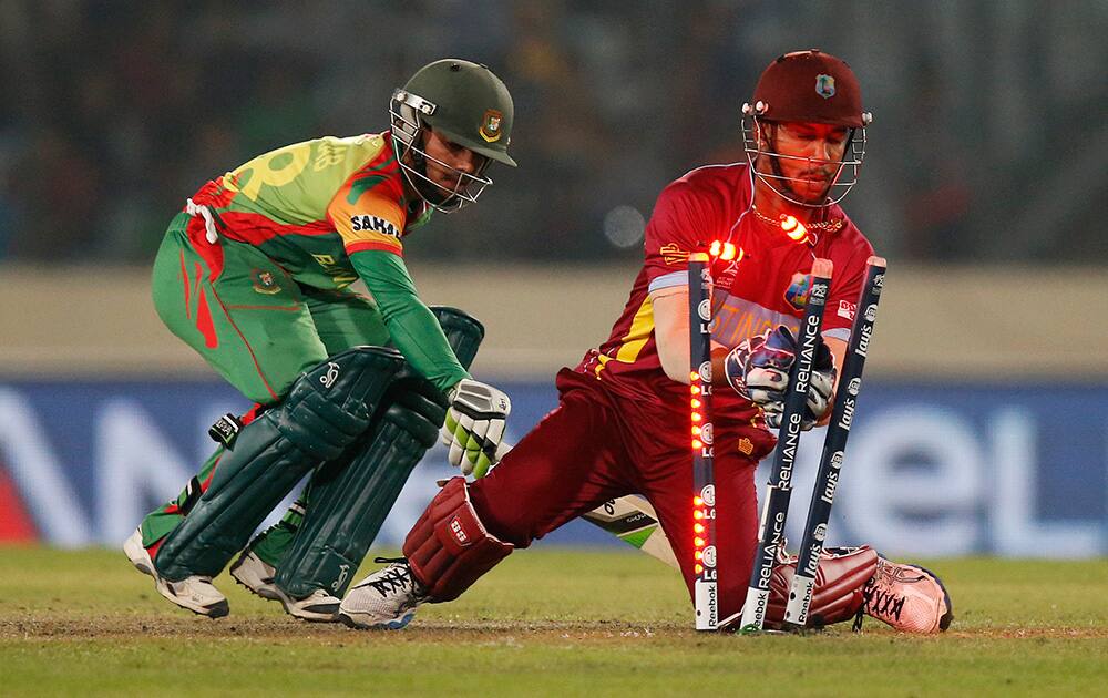 West Indies' wicketkeeper Lendl Simmons, right, attempts unsucessfully to dismiss Bangladesh batsman Mominul Haque, left, during their ICC Twenty20 Cricket World Cup match in Dhaka, Bangladesh.