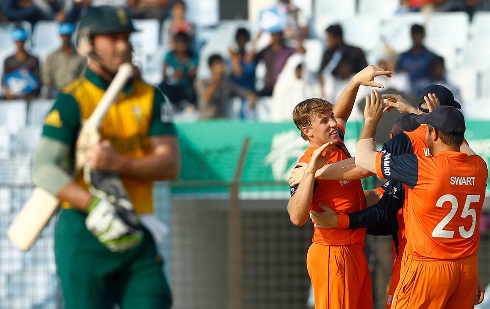 Netherlands' Logan van Beek celebrates with teammates the dismissal of South Africa's AB de Villiers during their ICC Twenty20 Cricket World Cup match in Chittagong, Bangladesh.
