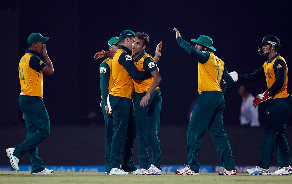South African cricketer Imran Tahir celebrates with his teammates the dismissal of Netherlands' Pieter Seelaar during their ICC Twenty20 Cricket World Cup match in Chittagong, Bangladesh.