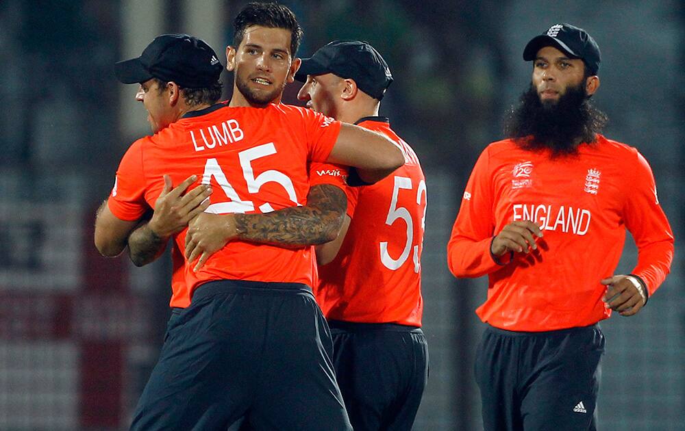 England's Jade Dernbach celebrates with teammates the dismissal of Sri Lanka's Kusal Perera during their ICC Twenty20 Cricket World Cup match in Chittagong, Bangladesh.