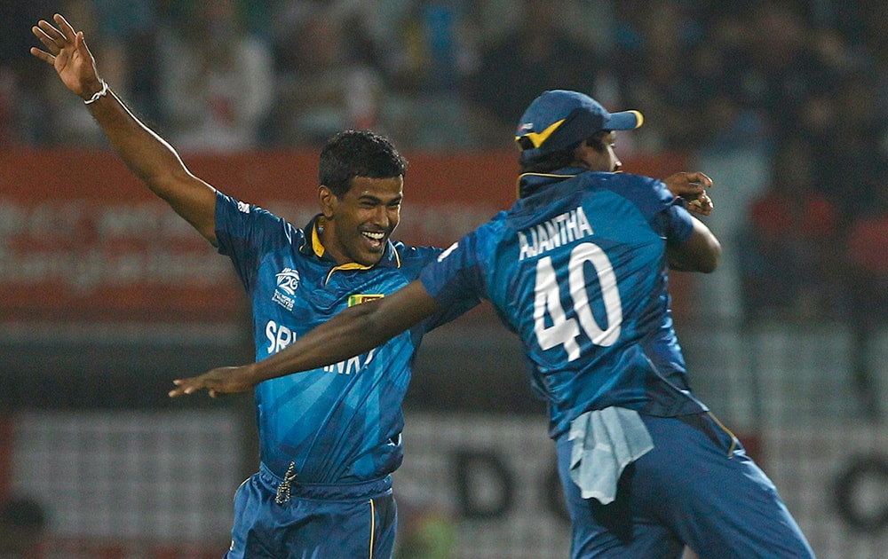 Sri Lanka's Nuwan Kulasekara celebrates with teammate Ajantha Mendis the dismissal of England's Michael Lumb during their ICC Twenty20 Cricket World Cup match in Chittagong, Bangladesh.