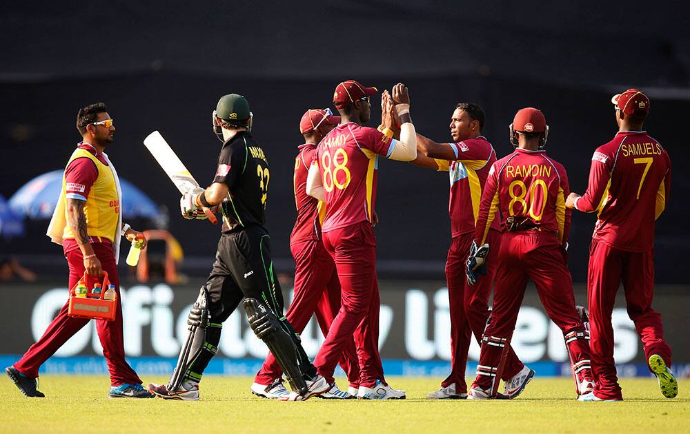West Indies' bowler Samuel Badree, third right, celebrates with teammates the dismissal of Australia's batsman Glenn Maxwell, second left, during their ICC Twenty20 Cricket World Cup match in Dhaka, Bangladesh.