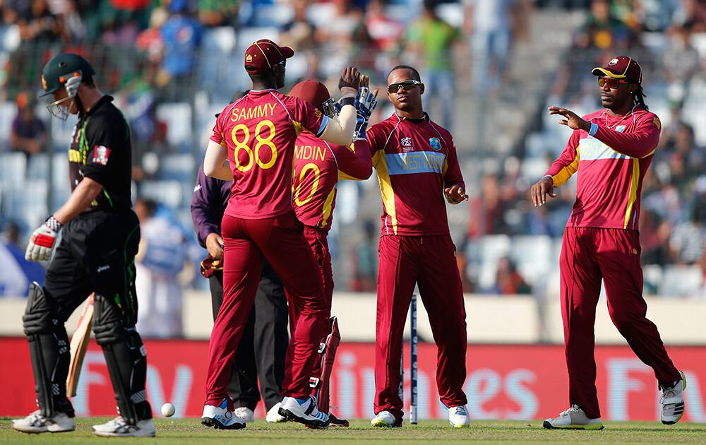 West Indies' bowler Marlon Samuels celebrates with teammates the dismissal of Australia's captain George Bailey during their ICC Twenty20 Cricket World Cup match in Dhaka, Bangladesh.