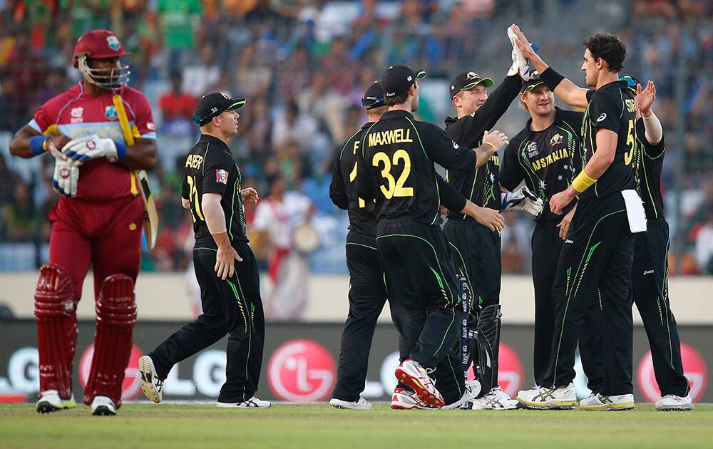Australia's bowler Mitchell Starc celebrates with teammates the dismissal of West Indies' batsman Dwayne Smith during their ICC Twenty20 Cricket World Cup match in Dhaka, Bangladesh.
