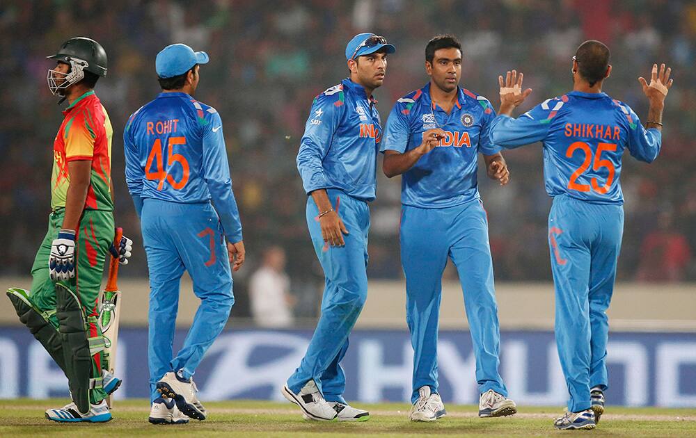 India's bowler Ravichandran Ashwin celebrates with teammates the dismissal of Bangladesh batsman Tamim Iqbal during their ICC Twenty20 Cricket World Cup match in Dhaka, Bangladesh.