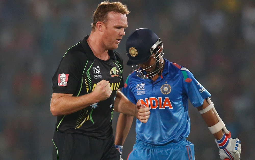 Australia's bowler Doug Bollinger, left, celebrates the dismissal of India's batsman Ajinkya Rahane, right, during their ICC Twenty20 Cricket World Cup match in Dhaka, Bangladesh.