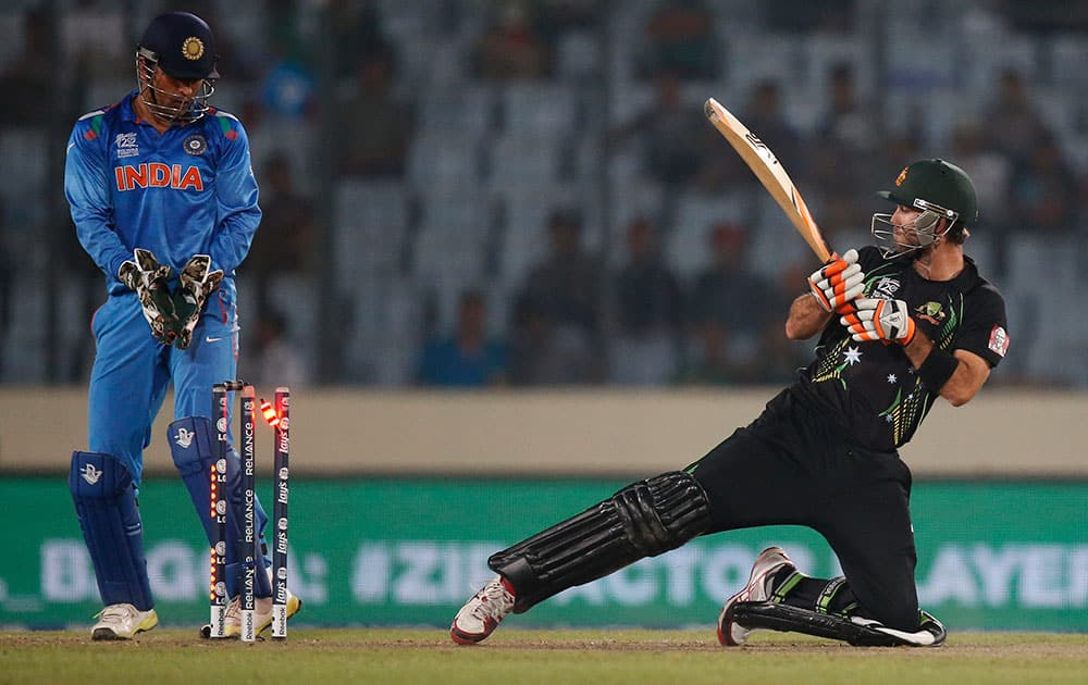 Australia's batsman Glenn Maxwell, right, is bowled out by India's bowler Ravichandran Ashwin during their ICC Twenty20 Cricket World Cup match in Dhaka, Bangladesh.