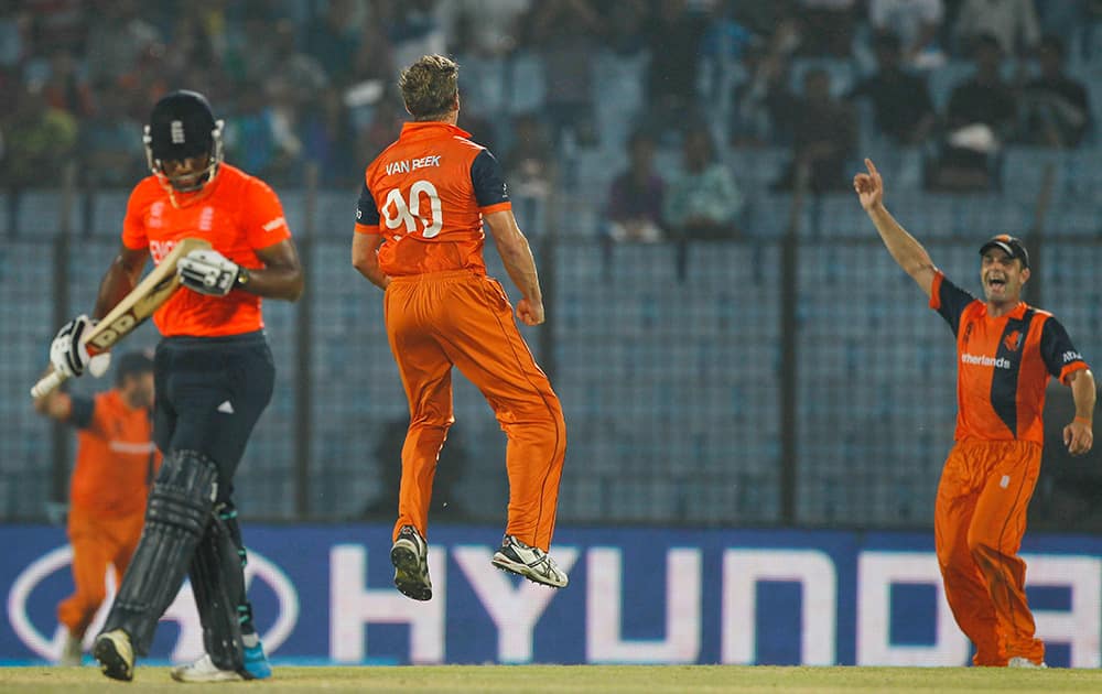 Netherlands's Logan van Beek jumps in the air as he celebrates the wicket of England's Chris Jordan during their ICC Twenty20 Cricket World Cup match in Chittagong, Bangladesh.