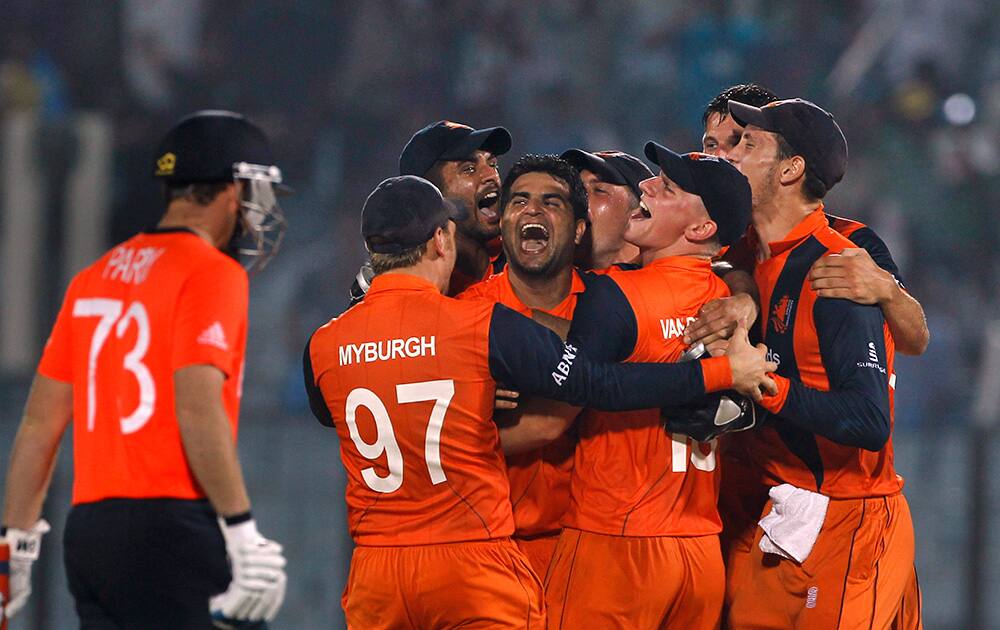 Netherlands players celebrate their victory against England during their ICC Twenty20 Cricket World Cup match in Chittagong, Bangladesh. Netherlands won by 45 runs.