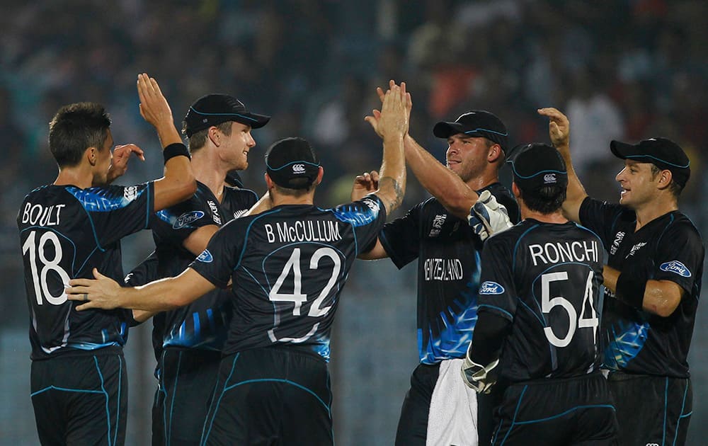 New Zealand's Trent Boult celebrates with his teammates the wicket of Sri Lanka's Kusal Perera during their ICC Twenty20 Cricket World Cup match in Chittagong, Bangladesh.