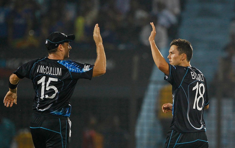 New Zealand's Trent Boult celebrates with his teammate Nathan McCullum the wicket of Sri Lanka's Tillakaratne Dilshan during their ICC Twenty20 Cricket World Cup match in Chittagong, Bangladesh.