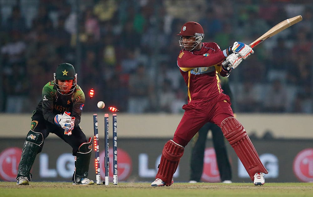 West Indies' batsman Marlon Samuels, right, is bowled out by Pakistan's bowler Shahid Afridi during their ICC Twenty20 Cricket World Cup match in Dhaka, Bangladesh.