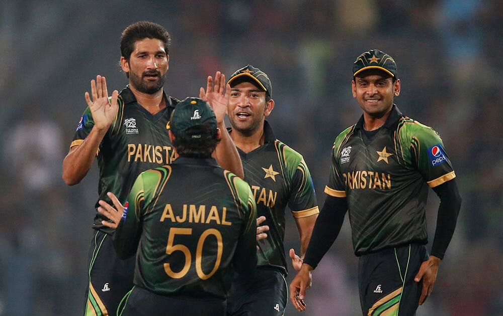 Pakistan's bowler Sohail Tanvir, left, celebrates with teammates the dismissal of West Indies' batsman Dwayne Smith during their ICC Twenty20 Cricket World Cup match in Dhaka.