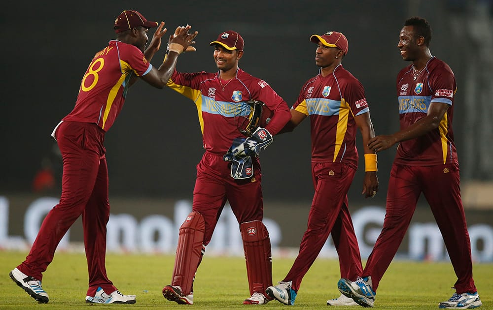 West Indies' captain Darren Sammy, left, celebrates with teammates after their win over Pakistan in the ICC Twenty20 Cricket World Cup match in Dhaka, Bangladesh.