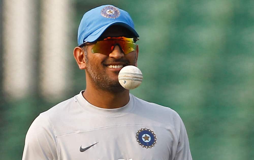 India's captain Mahendra Singh Dhoni thows a ball during a training session ahead of their ICC Twenty20 Cricket World Cup semi-final match against South Africa in Dhaka, Bangladesh.
