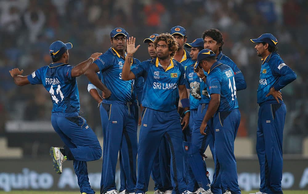 Sri Lanka's players celebrate the dismissal of West Indies' batsman Dwayne Smith during their ICC Twenty20 Cricket World Cup semi-final match in Dhaka, Bangladesh.