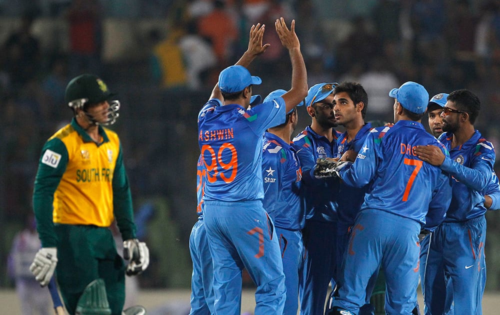 India's bowler Bhuvneshwar Kumar celebrates with teammates the dismissal of South Africa's batsman Quinton de Kock during their ICC Twenty20 Cricket World Cup semi-final match in Dhaka, Bangladesh.