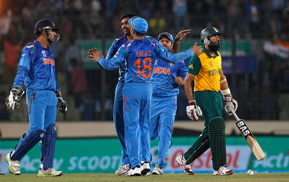 India's Ravichandran Ashwin celebrates with teammates the dismissal of South Africa's Hashim Amla during their ICC Twenty20 Cricket World Cup semifinal match in Dhaka, Bangladesh.