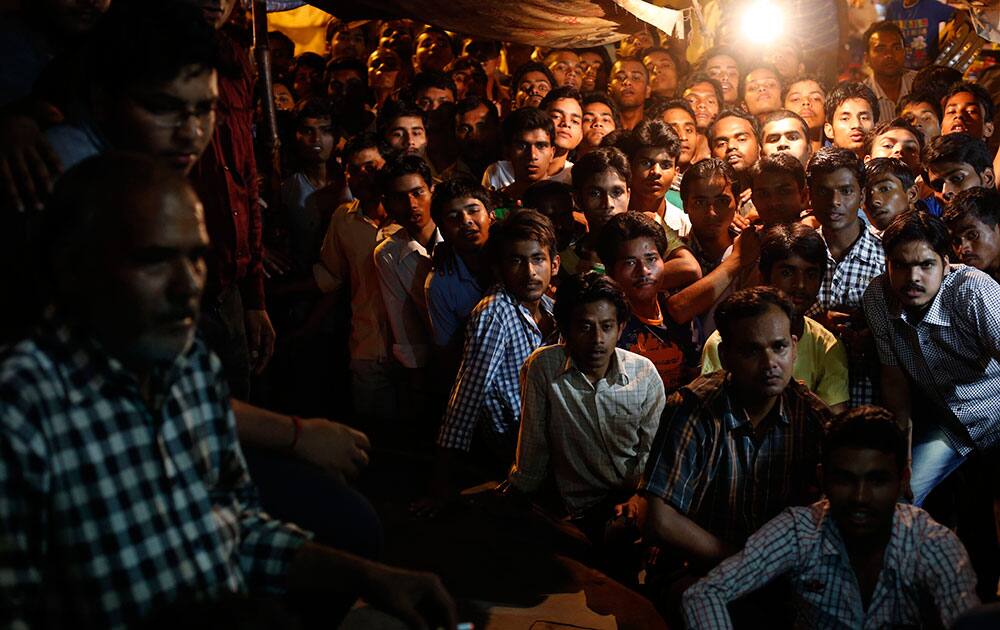 Indian cricket fans watch the ICC Twenty20 Cricket World Cup final match between India and Sri Lanka on a television set at a roadside eatery in Allahabad.