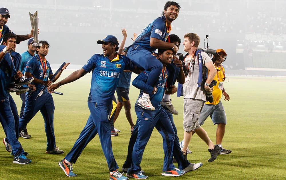 Sri Lanka's players lift Kumar Sangakkara, as they acknowledge the crowd after their win over India in the ICC Twenty20 Cricket World Cup final match in Dhaka.