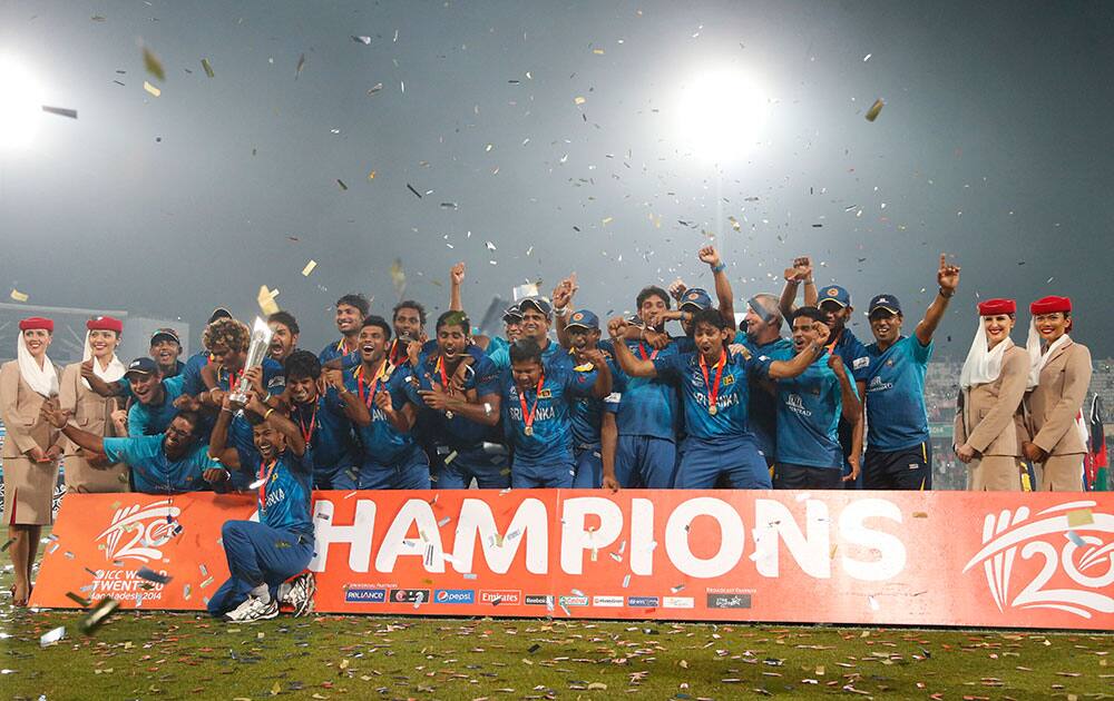 Sri Lankan players and support staff celebrate with the winners trophy after their win over India in the ICC Twenty20 Cricket World Cup final match in Dhaka.
