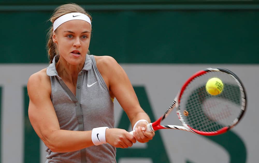 Slovakia's Anna Schmiedlova returns the ball to China's Zheng Jie during the first round match of the French Open tennis tournament at the Roland Garros stadium, in Paris.