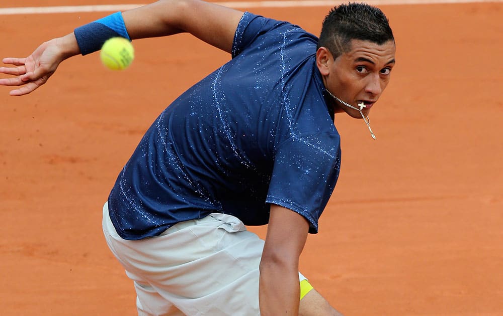 Australia's Nick Kyrgios returns the ball to Canada's Milos Raonic during the first round match of the French Open tennis tournament at the Roland Garros stadium, in Paris.