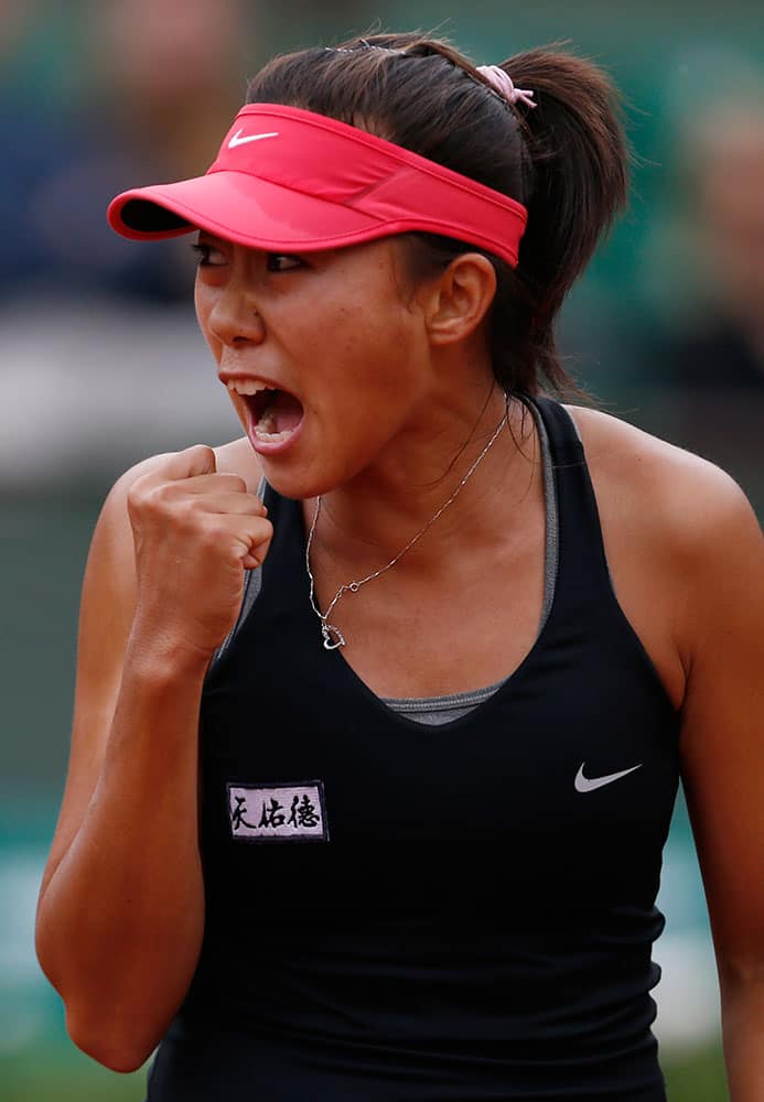 China's Zhang Shuai reacts as she plays Poland's Agnieszka Radwanska during the first round match of the French Open tennis tournament at the Roland Garros stadium, in Paris.