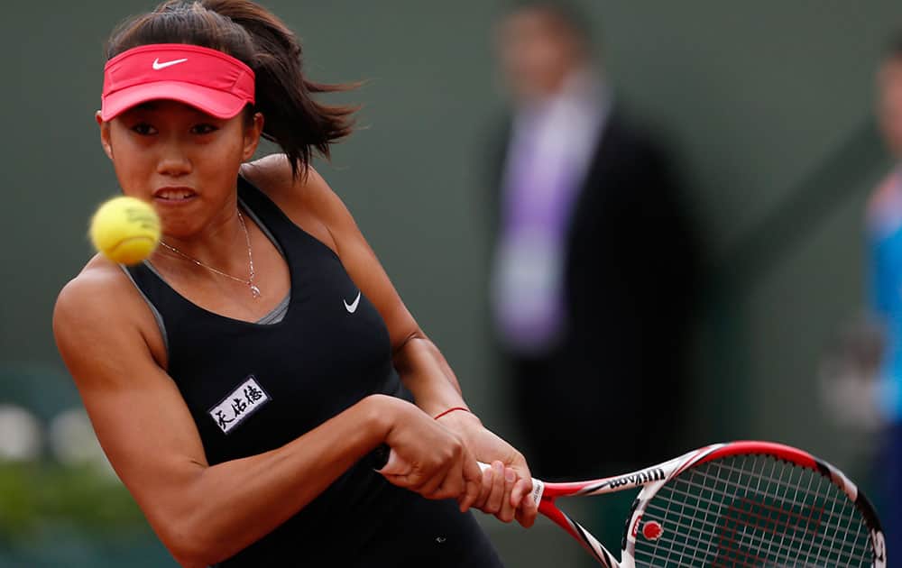 China's Zhang Shuai returns the ball to Poland's Agnieszka Radwanska during the first round match of the French Open tennis tournament at the Roland Garros stadium, in Paris.