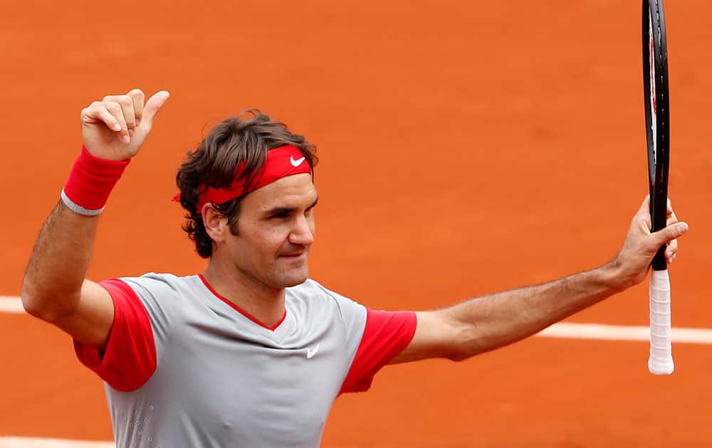 Switzerland's Roger Federer thumbs up after defeating Slovakia's Lukas Lacko in the first round match of the French Open tennis tournament at the Roland Garros stadium, in Paris.