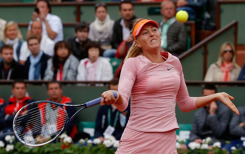 Russia's Maria Sharapova returns the ball to compatriot Ksenia Pervak during their first round match of the French Open tennis tournament at the Roland Garros stadium, in Paris, France.