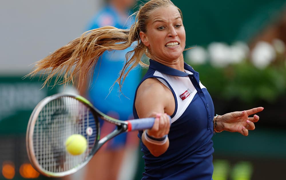 Slovakia's Dominika Cibulkova returns the ball to France's Virginie Razzano during the first round match of the French Open tennis tournament at the Roland Garros stadium, in Paris, France.