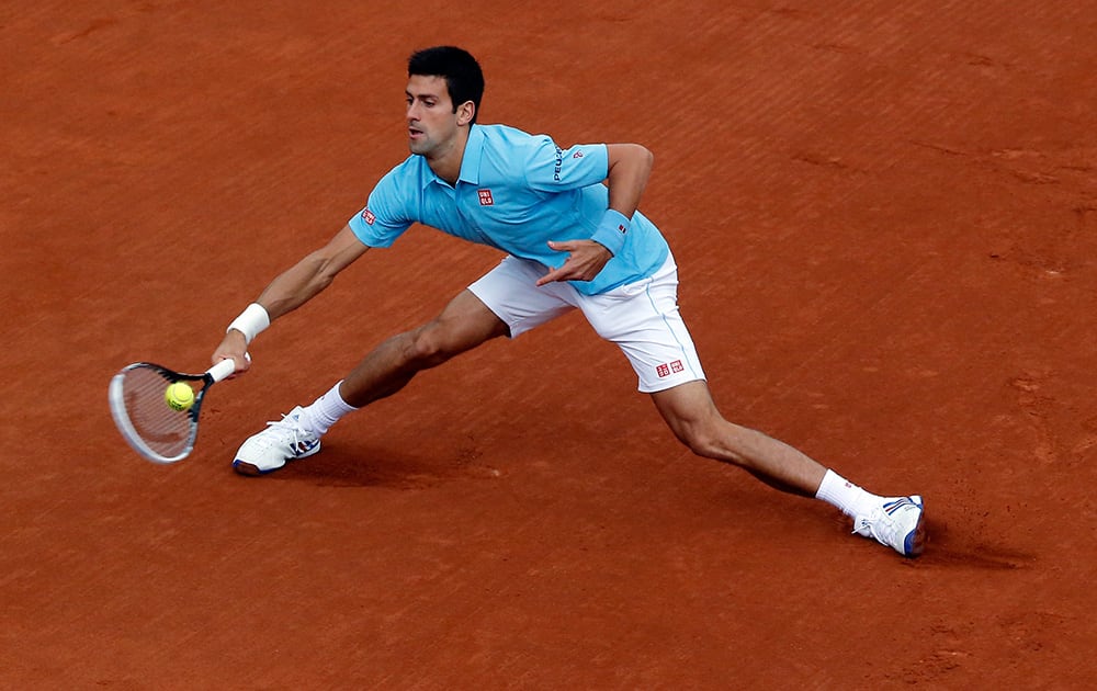 Serbia's Novak Djokovic returns the ball to Portugal's Joao Sousa during their first round match of the French Open tennis tournament at the Roland Garros stadium, in Paris, France.