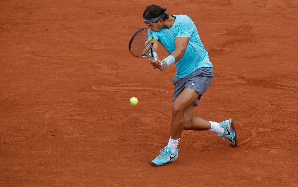Spain's Rafael Nadal returns the ball during the first round match of the French Open tennis tournament against Robby Ginepri of the U.S. at the Roland Garros stadium, in Paris, France.