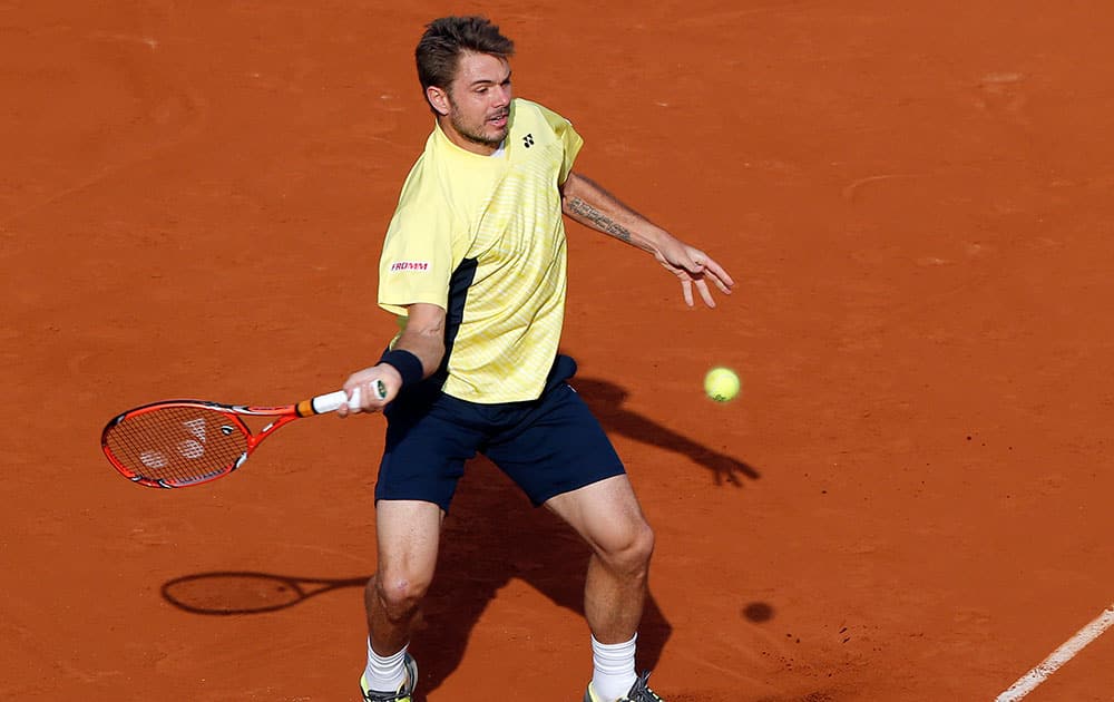 Switzerland's Stanislas Wawrinka returns the ball to Spain's Guillermo Garcia-Lopez during the first round match of the French Open tennis tournament at the Roland Garros stadium, in Paris.
